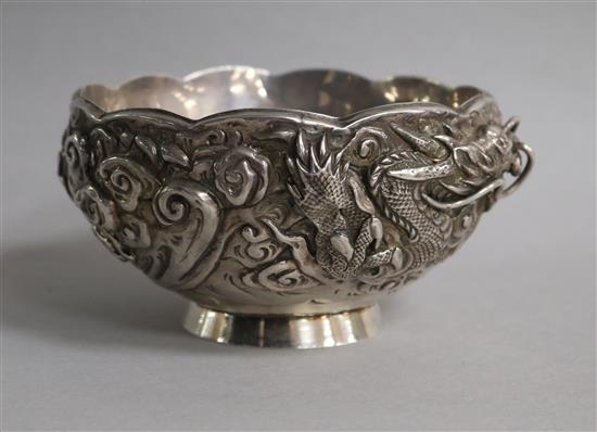An early 20th century Japanese double skinned white metal bowl, decorated with a dragon, diameter 13.2cm.